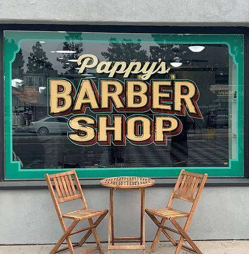 Hand painted gold leaf Pappy's Barber Shop sign on the College Area storefront window