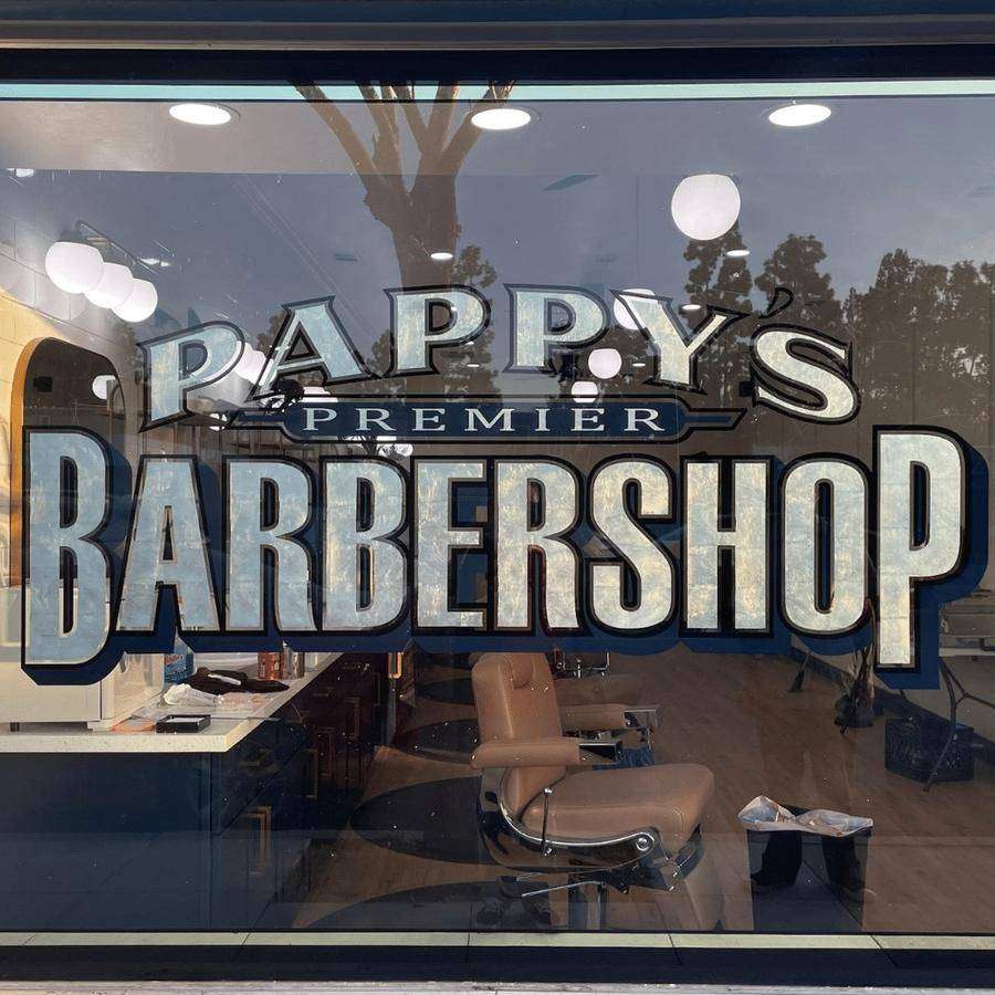 Pappy's Premier Barber Shop storefront window with gold lettering